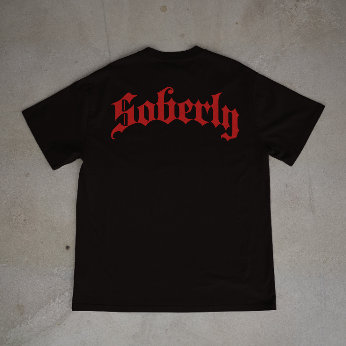 Soberly unisex black "NA raised me" T-shirt